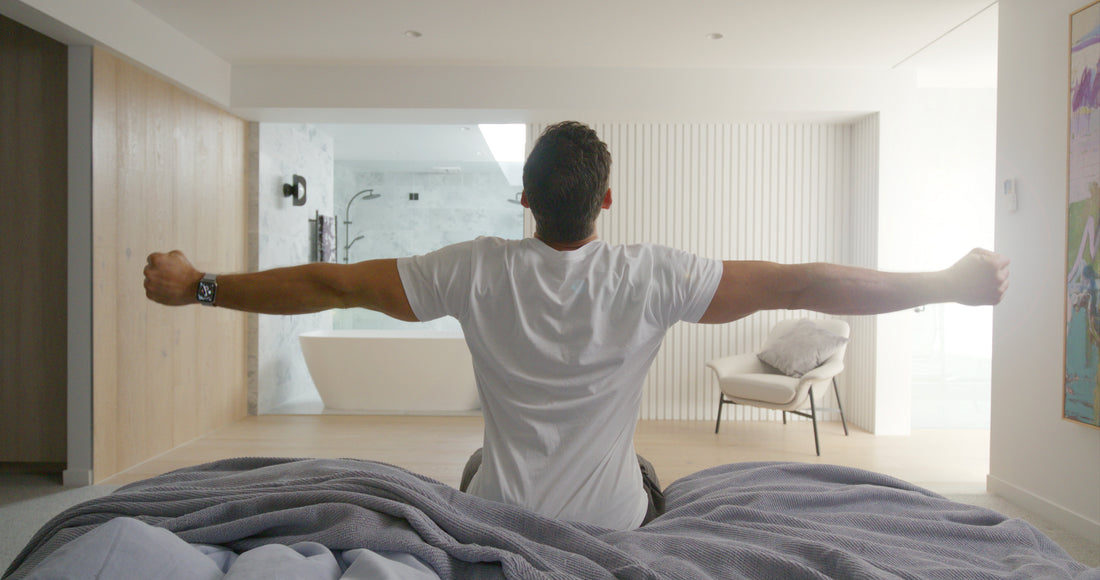 man morning stretch on end of bed